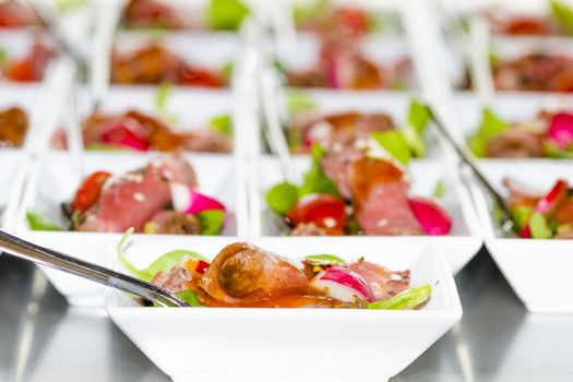 Colorful snacks (appetizers) in white cups with forks on table. Healthy diet or lifestyle concept. Low angle and selective focus. Colorful.