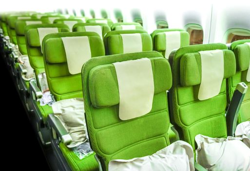 Green Airplane seats in cabin. Interior view