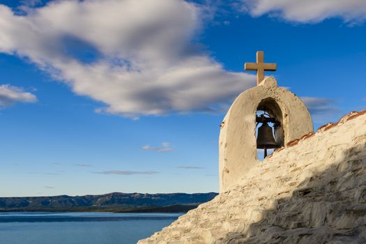 Small stone chappel in the Mediterranean, island of Brac, Croatia / morning daylight, Hvar in background