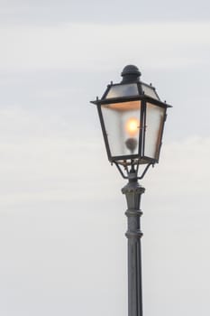 Vintage, old street lamp in classic style, made of cast iron and or metal