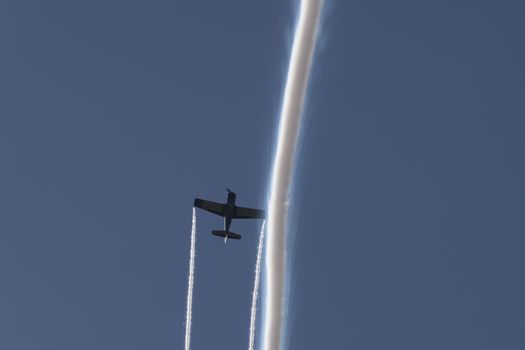 T-28B Trojan trainer aircraft performing aerobatics at airshow with smoke trails