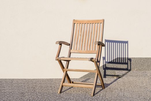 Foldable deck chair on outdoor terrace, made of teak tropical hardwood