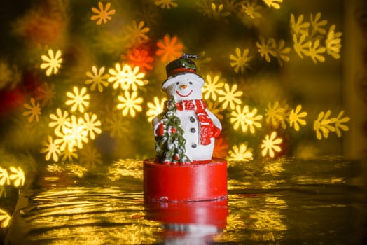 Christmas snowman and flower shaped lights in background, flower shaped bokeh blur, Christmas decoration