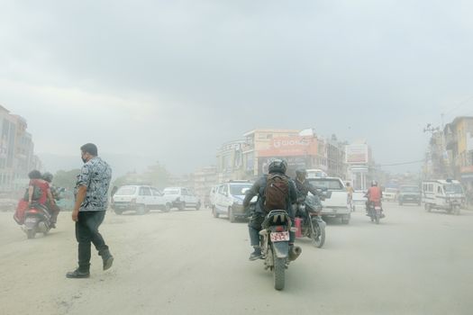 NEPAL. KATHMANDU — MAY 30, 2017 : Dense road dust from traffic on a busy street in Kathmandu. Kathmandu is the capital and the largest city of Nepal.