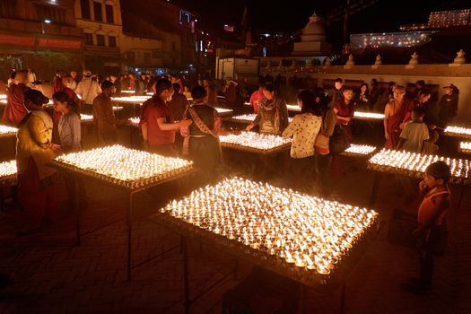 NEPAL. KATHMANDU — MAY 03, 2017 : The offering of burning oil lamps near the stupa  Bouddanath in Kathmandu. Kathmandu is the capital and the largest city of Nepal.