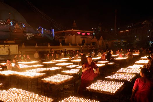 NEPAL. KATHMANDU — MAY 03, 2017 : The offering of burning oil lamps near the stupa  Bouddanath in Kathmandu. Kathmandu is the capital and the largest city of Nepal.