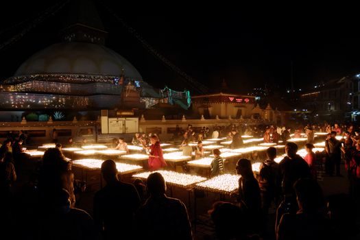 NEPAL. KATHMANDU — MAY 03, 2017 : The offering of burning oil lamps near the stupa  Bouddanath in Kathmandu. Kathmandu is the capital and the largest city of Nepal.