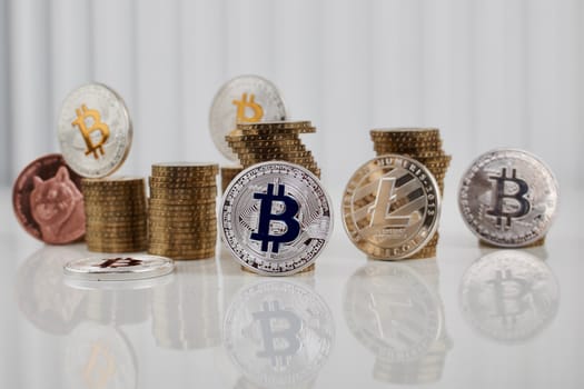 Digital currency physical silver bitcoin coin near silver litecoin coin and brass dogecoin.