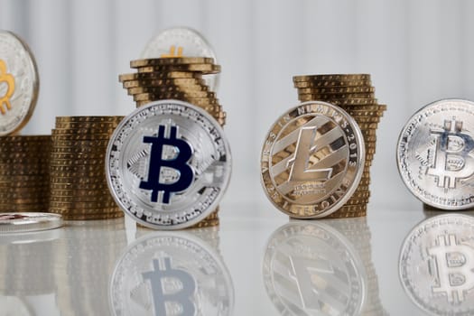 Digital currency physical silver Litecoin coin money concept with silver bitcoins on the white table.