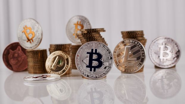 Digital currency physical silver bitcoin coin near gold money on the table.