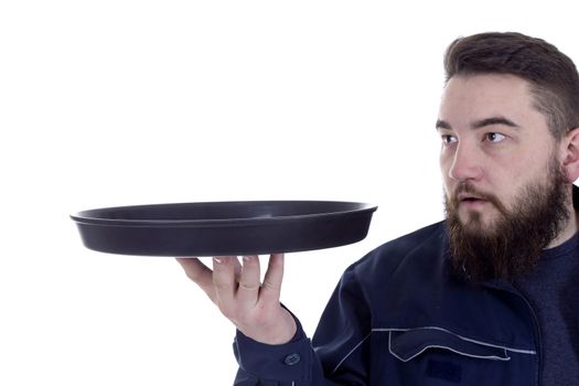 Bearded young man with a tray on a white background