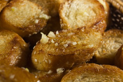 Roasted garlic bread close-up in wicker basket