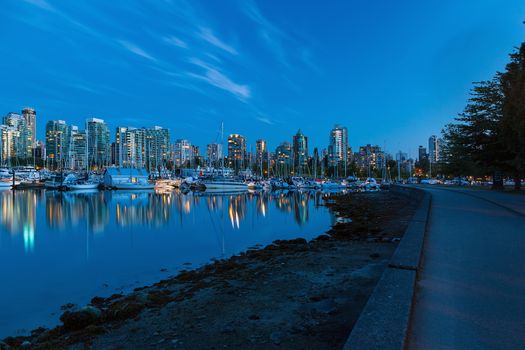 Vancouver British Columbia Canada skyline by the marina along Stanley Park seawall during evening blue hour