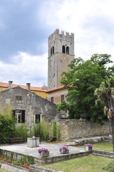 Medieval istrian town of Motovun, Croatia, shot from the castles garden, showing the tower, a well and ancient houses.