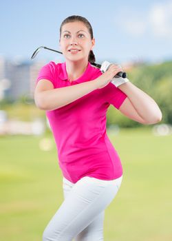 charming young athlete with a golf club on a background of golf courses