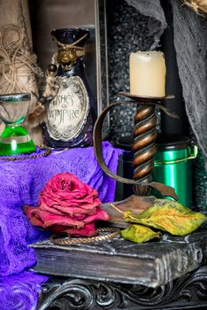 candlestick closeup on a table with a witch's props for rituals