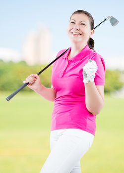 joyful woman golfer enjoys his victory on a background of golf courses