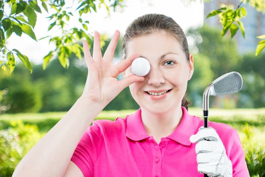 horizontal portrait of funny girl golfer with equipment for playing golf on a background of golf courses
