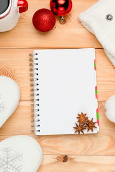 Christmas objects on the wooden floor close-up, in the center of the notebook with anise