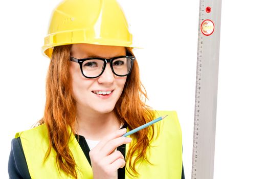 close-up portrait of a superintendent in a helmet with a ruler isolated