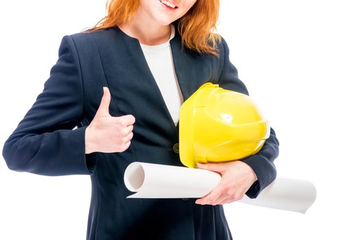 Woman boss with yellow helmet and blueprints, focus on hands