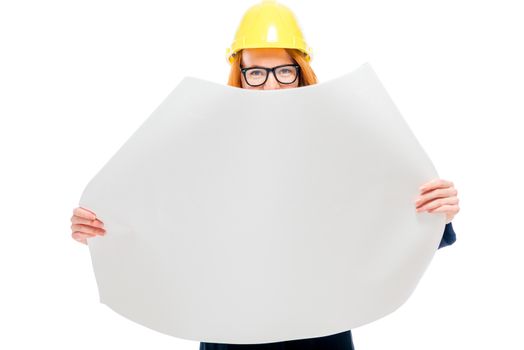 architect with blueprints on a white background in studio in a yellow hard hat