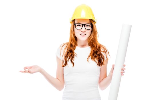 young beautiful red-haired woman with blueprints in a yellow hard hat against a white background