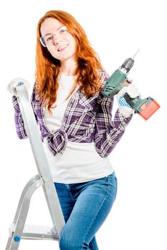 beautiful girl with red hair on a stepladder with a drill pose