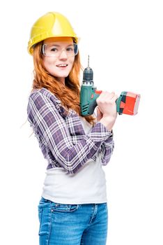 smiling woman in protective helmet with a male tool on a white background