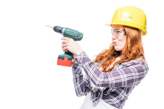 fragile girl with a man's tool on a white background, space left