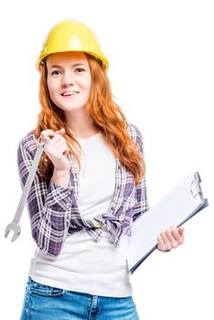 isolated portrait of a woman with tools in a yellow hard hat