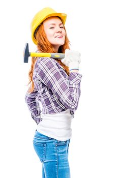 successful woman with a hammer in a yellow hard hat against a white background