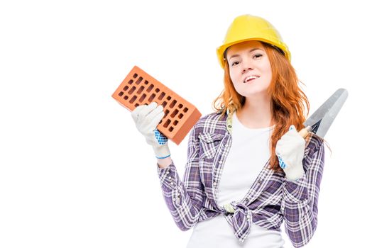 horizontal portrait of a woman builder with a brick and trowel isolated