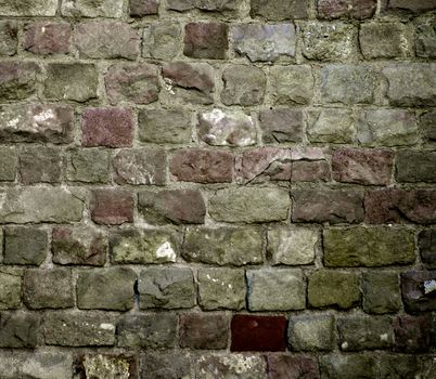 Background of Various Colored Old Damaged Bricks with Concrete Smoothing closeup Outdoors