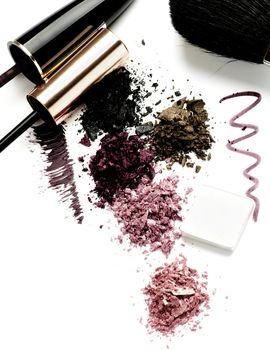 Arrangement of Makeup Brushes, Eyeliner, Mineral Smokey Eyes Shadows and Mascara isolated on White background
