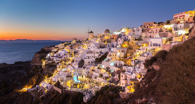 World famous Oia village or Ia at sunset, Santorini island, Greece.