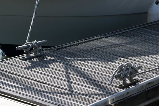 Decking of a marina pontoon with roped cleats