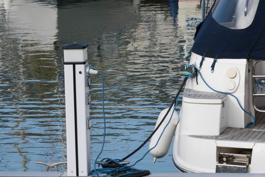 An electricity point for yachts on a pontoon in a marina