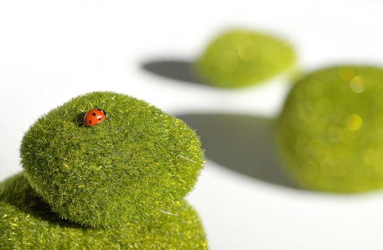 Stack of green stones and ladybug