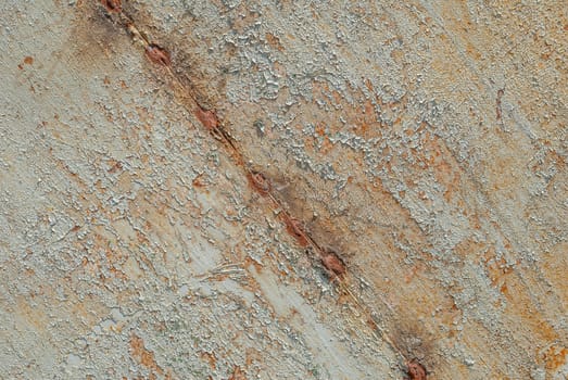 fragment of a rusty iron surface covered with old paint, which has long been under the influence of different climatic conditions