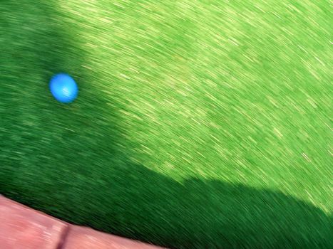 A golf ball rushing down the green