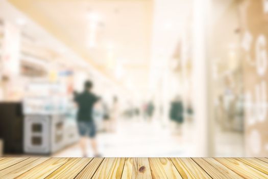 empty wooden front of abstract blur many people shopping in department store, urban lifestyle concept