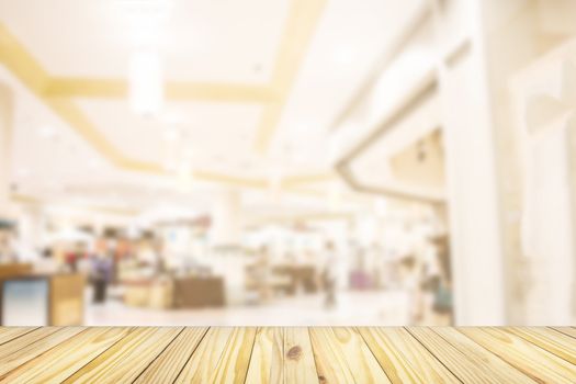 empty wooden front of abstract blur many people shopping in department store, urban lifestyle concept