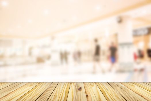 empty wooden front of abstract blur many people shopping in department store, urban lifestyle concept