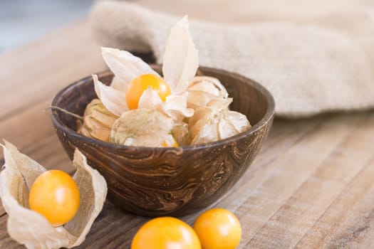 Cape gooseberry (Physalis) in wooden bowls