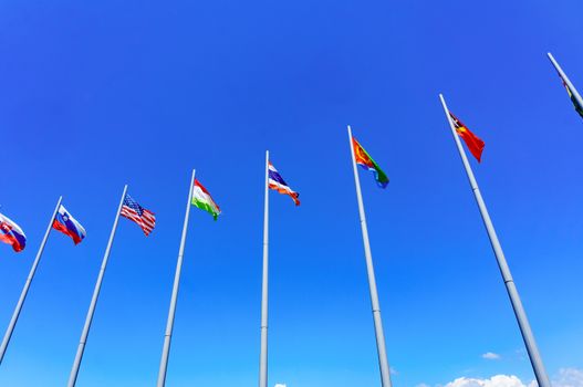 International flags against blue sky