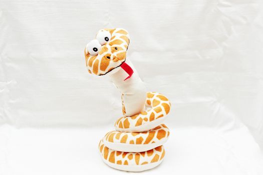 Funny soft snake toy isolated on white background.