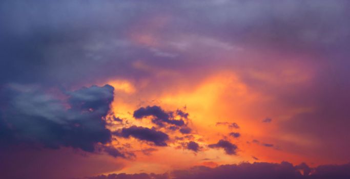 Sunset amid thunderclouds. Sunset shines red through dark clouds.                                                                                   