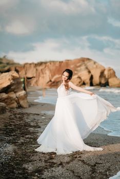 bride on the shore of the black sea in the sunset light