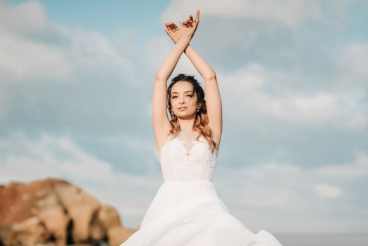 bride on the shore of the black sea in the sunset light